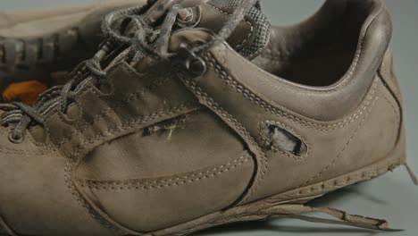 close dolly of pair of hiking shoes against a studio background