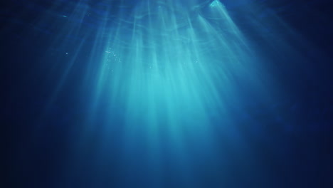 Underwater-sunlight-beams-shining-from-above-coming-through-the-deep-crystal-clear-blue-water-causing-a-beautiful-water-lighting-reflections-curtain