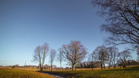 time lapse shot over a hilly landscape with trees and pasture