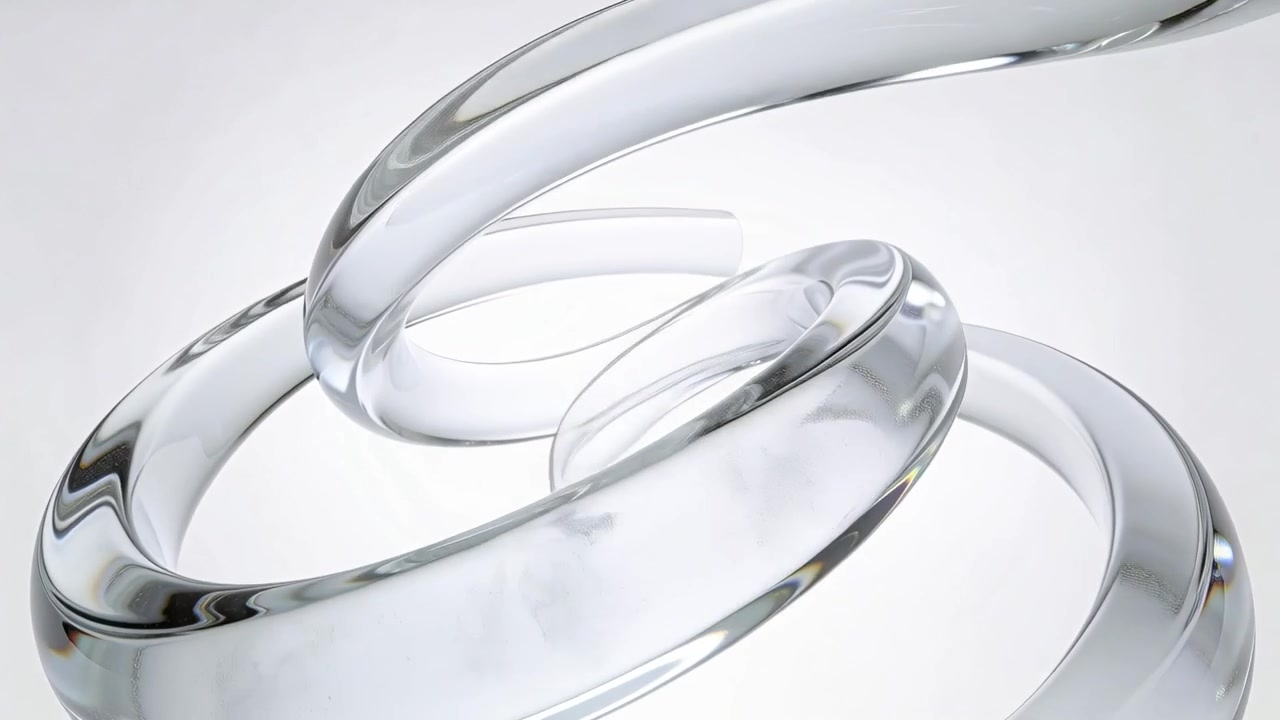 Pulling camera back revealing rotating glass helical coil on white gradient, showing refraction