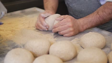 baker preparing a batch of fresh bread in a bakery