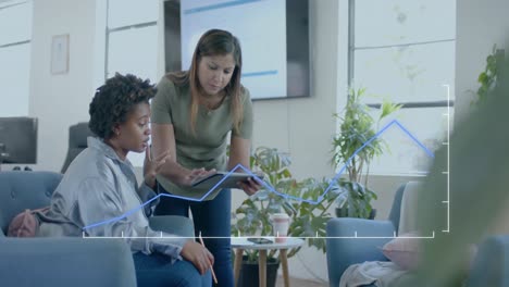 Graph-processing-data-over-diverse-female-colleagues-discussing-in-casual-office-lounge