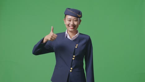 flight attendant smiling and giving thumbs up