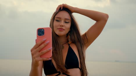woman taking selfie on a beach