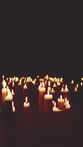 many candles burning in the darkness