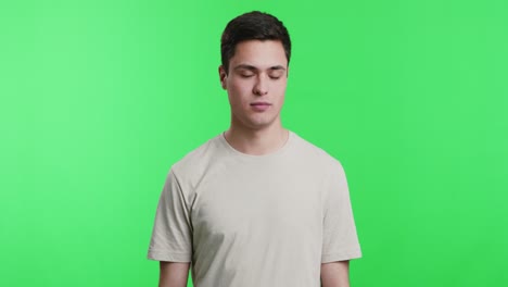 man in beige t-shirt with confused expression