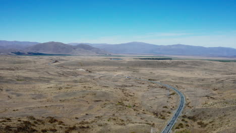 Drone-shot-of-the-vast-landscape-between-Lake-Pukaki-and-Tekapo-in-South-Island,-New-Zealand