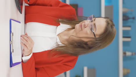 Vertical-video-of-Home-office-worker-woman-happy-and-smiling.