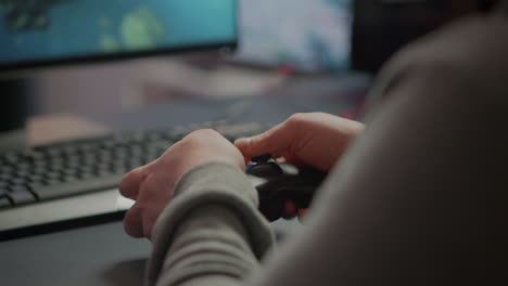 cerca de las manos del videojuego r jugando usando un joystic inalámbrico