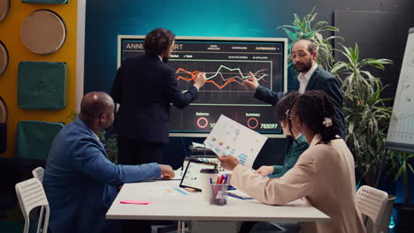 Project managers making presentation with annual reports to evaluate statistics