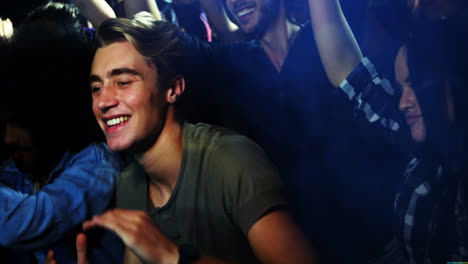 young man dancing at a concert 4k