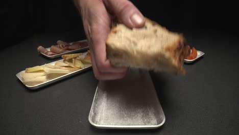 Close-up-shot-of-chef-plating-bread-with-apetizers