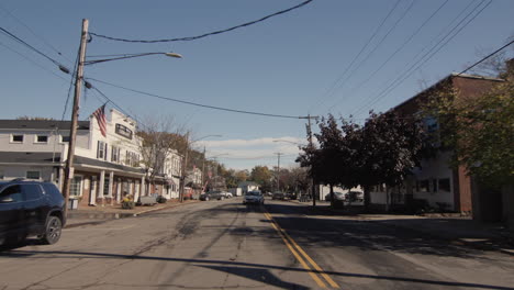 wilson, ny, usa, october 2021: driving down the street of a typical small american town