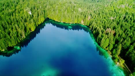 breathtaking aerial of laghi di fusine, an alpine lake with deep blue waters, 4k