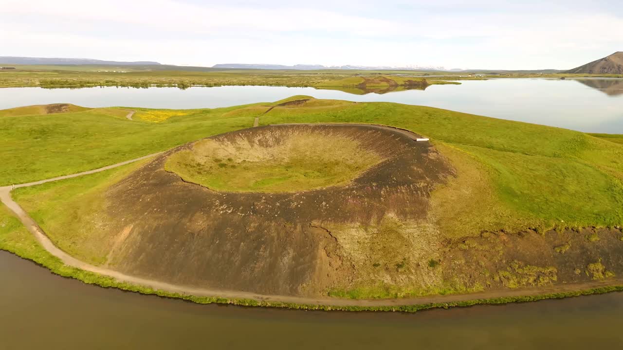 Witness the mesmerizing shapes of Skútustaðagígar from above, where volcanic activity has sculpted an extraordinary landscape filled with history and beauty.