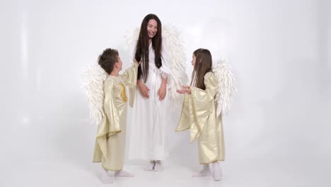 mom with son and daughter they have angel wings on a white background mom with son and daughter they have angel wings on a white background slow motion