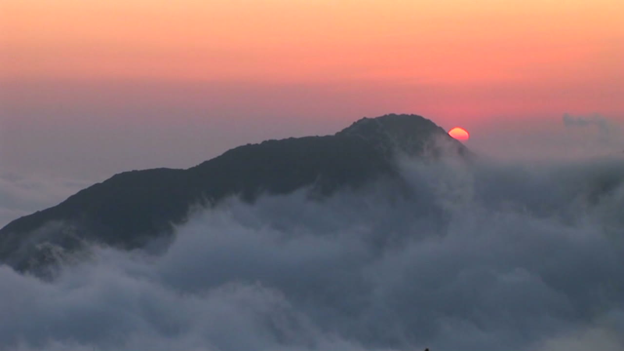 이 아름다운 저속 촬영에서 암석 위의 하늘을 가로지르는 구름