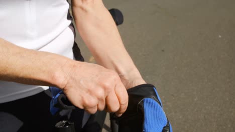 senior cyclist wearing fingerless gloves at countryside 4k