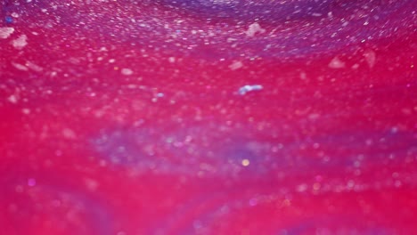 abstract ink swirling together, close-up of colorful pigment mixing in liquid