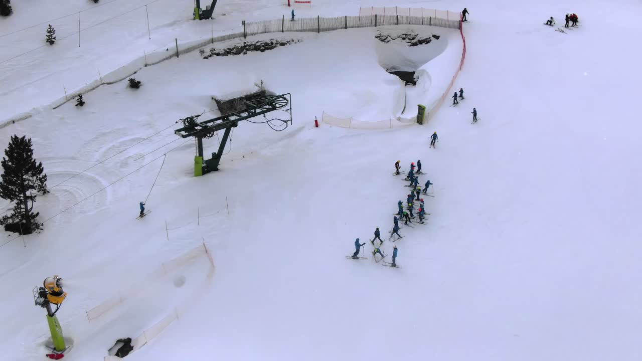 Aerial view of group of skiers at ski lift on snowy slope, Ordino Arcalis resort, Andorra