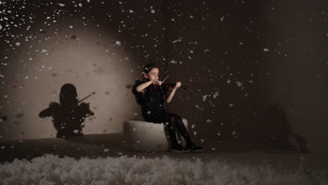 young girl playing violin in a wintery studio