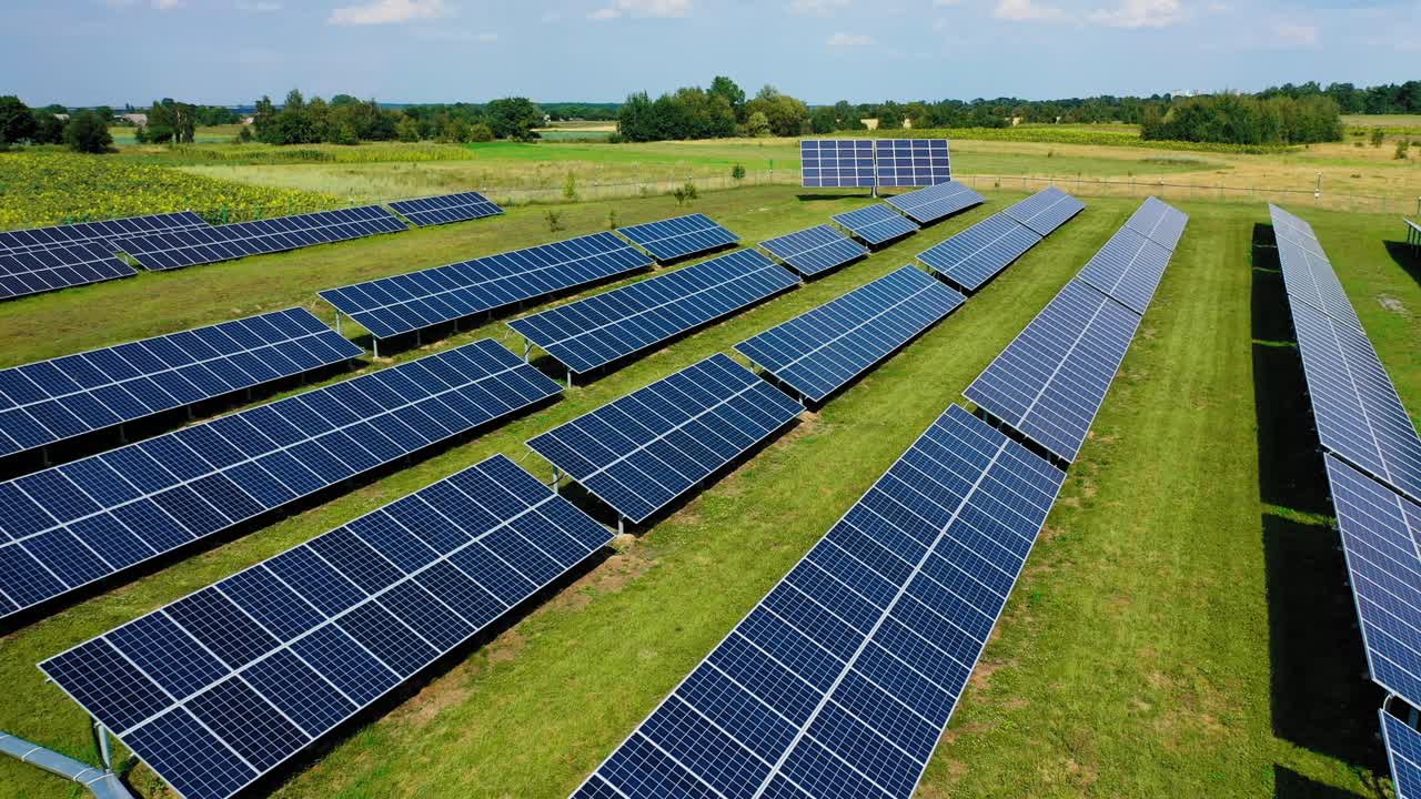 Top view of solar panels, solar cell in alternative energy farm with green grass and sun lighting reflect .Photovoltaic plant field. Eco energy.