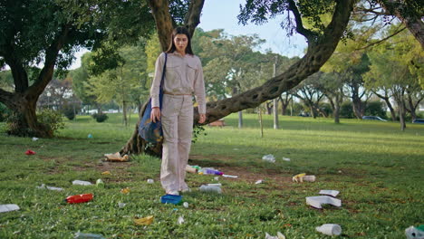 volunteer collecting park trash. eco-active girl cleaning green nature space