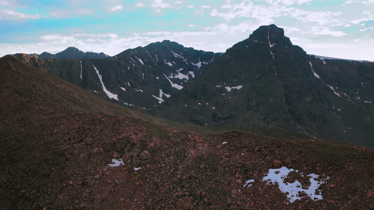 Halo Ridge Notch Mountain shelter landscape view of Mount of the Holy Cross 14er peak wilderness aerial drone Colorado summer afternoon sunset clouds Rocky Mountains Sawatch Range circle left