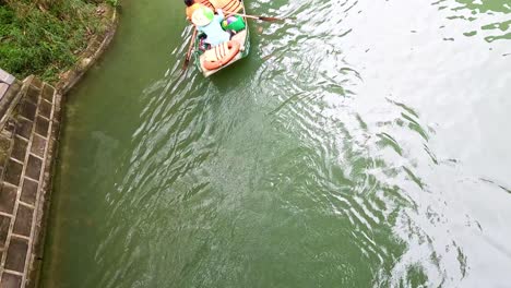 people rowing a boat through scenic waters