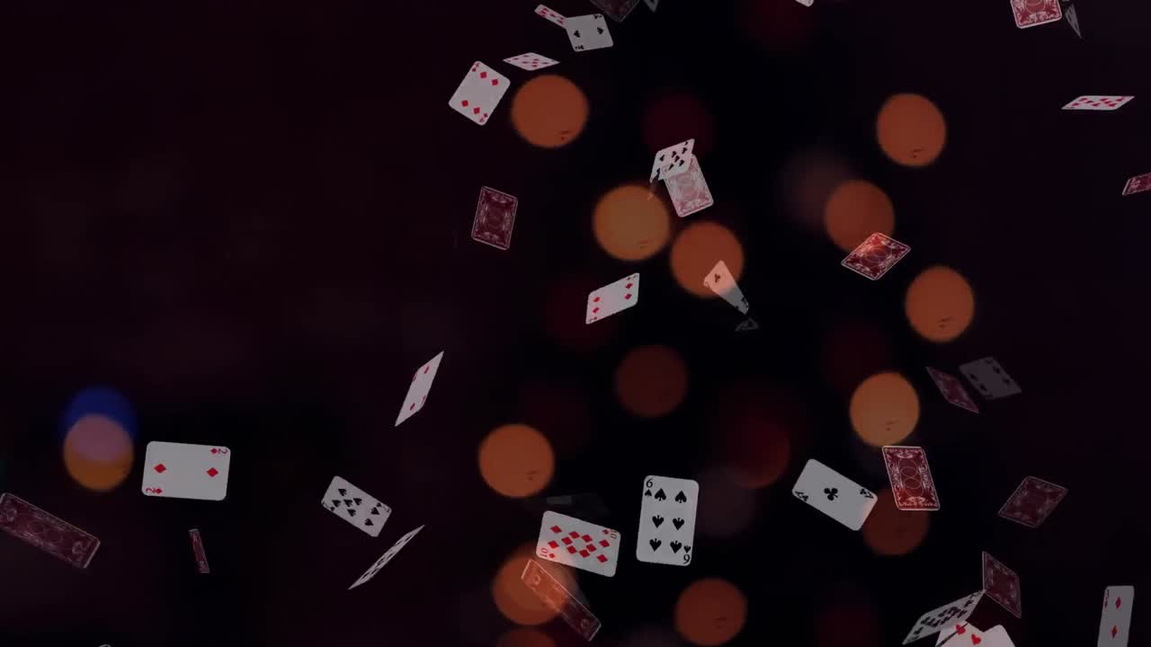 animación de luces bokeh sobre cartas de juego que caen sobre un fondo negro