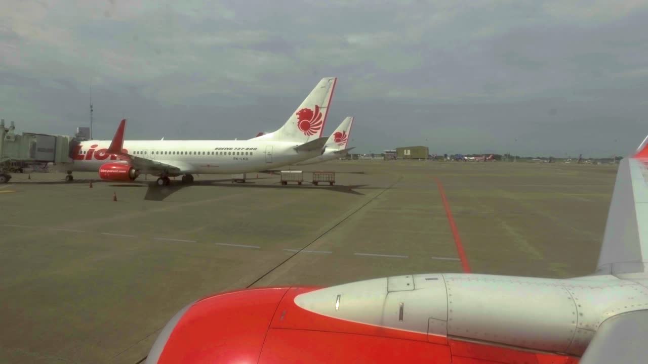 point of view in an airplane that is moving backwards to take off immediately