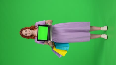 woman with laptop and shopping bags