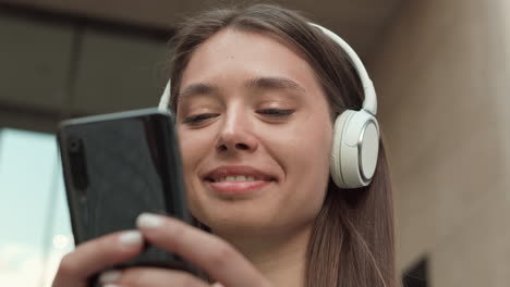 caucasian woman with smartphone and headphones