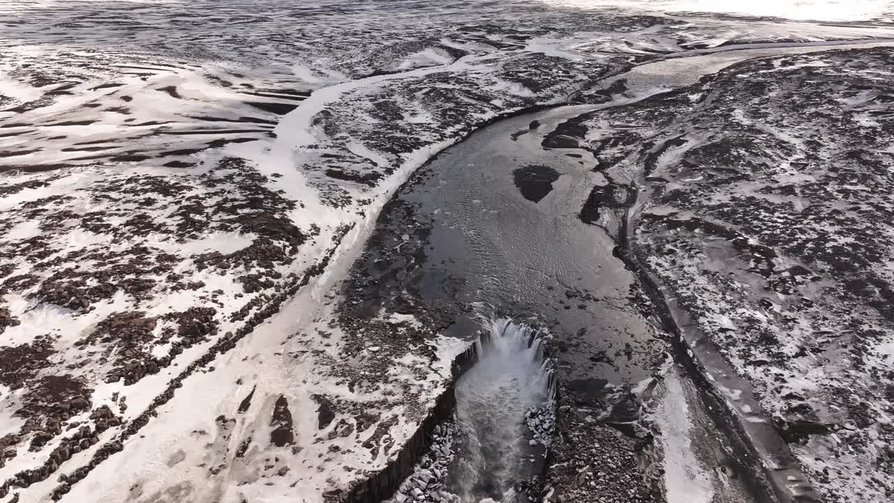 Selfoss waterfall plunging through icy terrain along the Jökulsá á Fjöllum River. Iceland