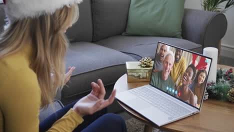 happy diverse friends having christmas laptop video call, slow motion