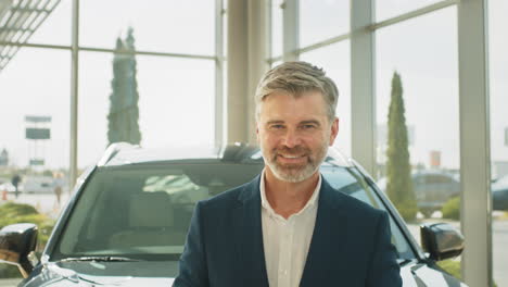 smiling car dealer in showroom