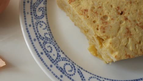delicious spanish potato omelette served on a plate, showing its soft texture and layers