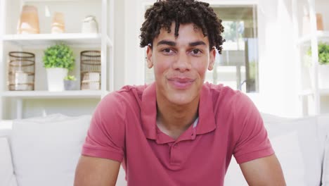 portrait of happy biracial man spending time at home and having video call