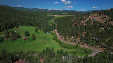 Mount-Blue-Sky-Evans-aerial-drone-neighborhood-south-Evergreen-Colorado-Rocky-Mountains-landscape-Spring-Summer-morning-North-Turkey-Creek-Road-Traffic-Red-Barn-Marshdale-sunny-forward-pan-up-slowly