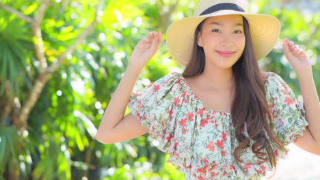 a cute young woman in a flowered sundress walks toward the camera smiling and flirting as she moves