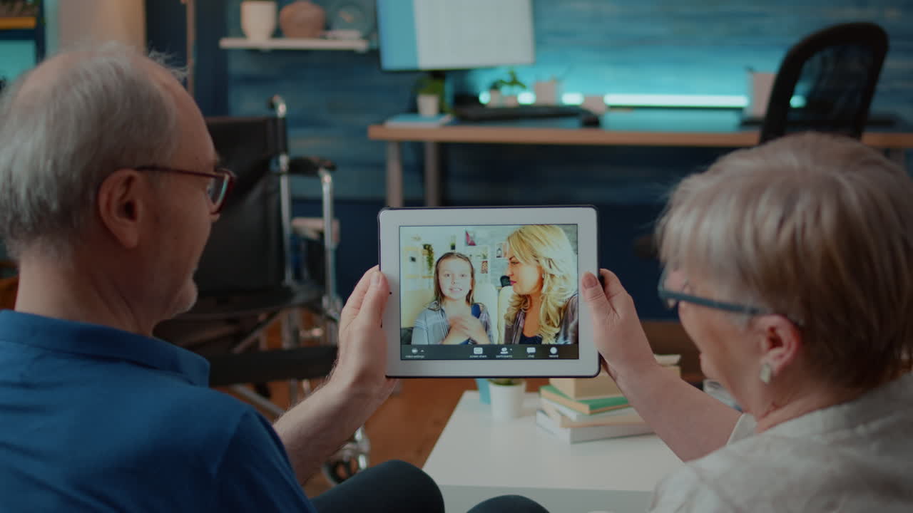 Senior couple having a video call with family on tablet