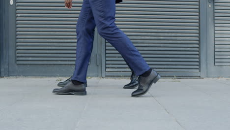 business men walking on pavement outside.businessmen taking walk on urban street