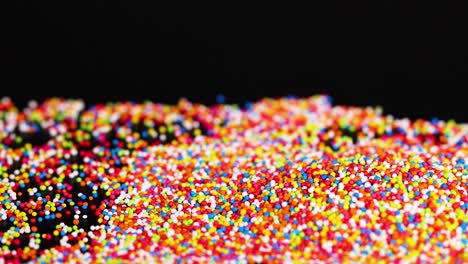 vibrant sprinkles cascading against a dark background