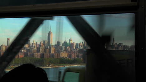 view of the new york skyline as seen from a passenger entering the city by bridge