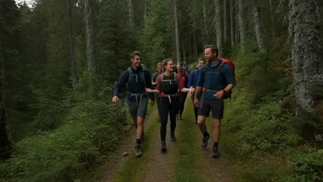 group of friends hiking through a green forest