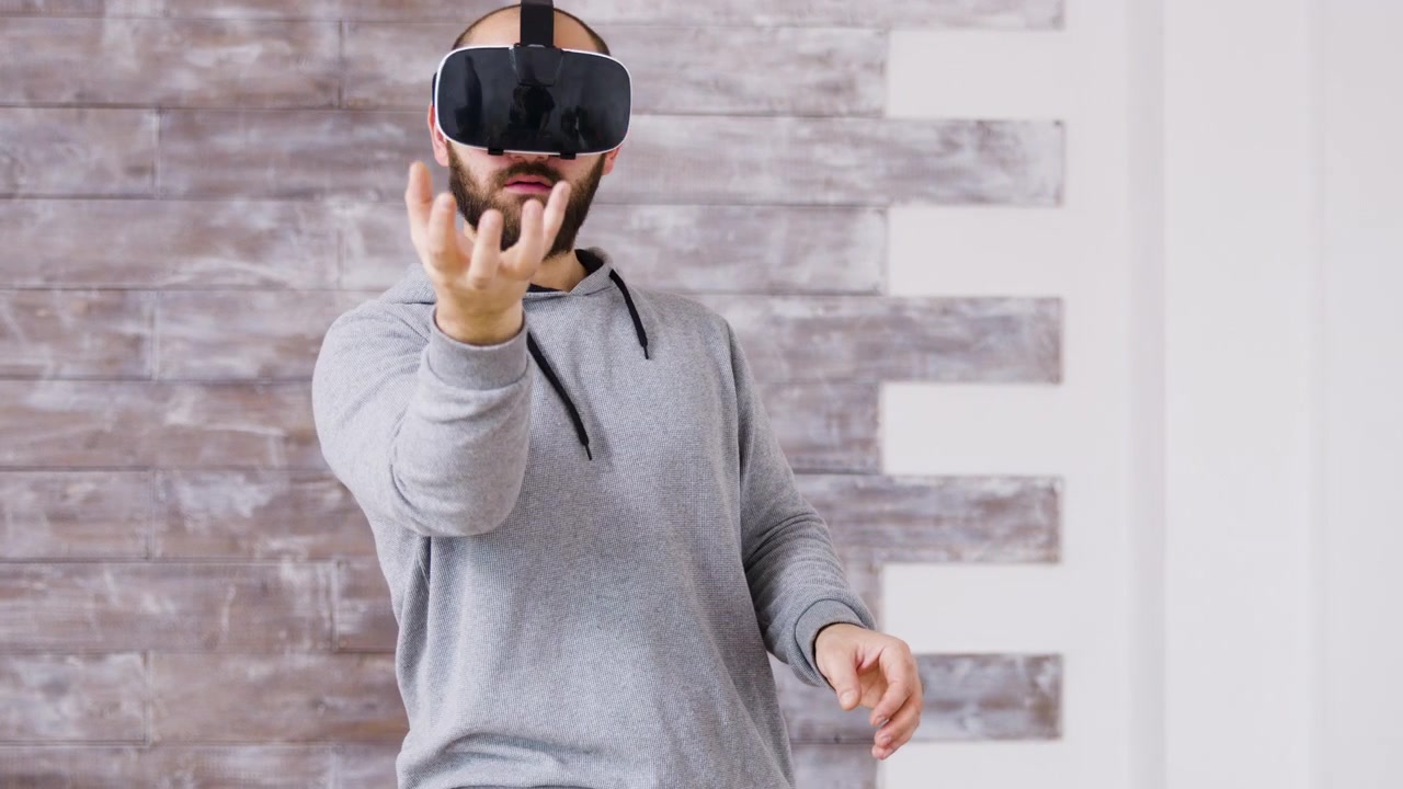 Man Wearing Virtual Reality Headset and Interacting with Digital Interface