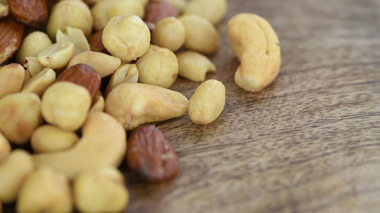 Portion of roasted nuts on a rotating plate (seamless loopable)