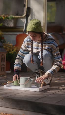 woman preparing tea outdoors in a campervan