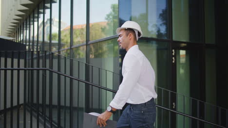 successful architect walking city holding folder closeup. man in hardhat working