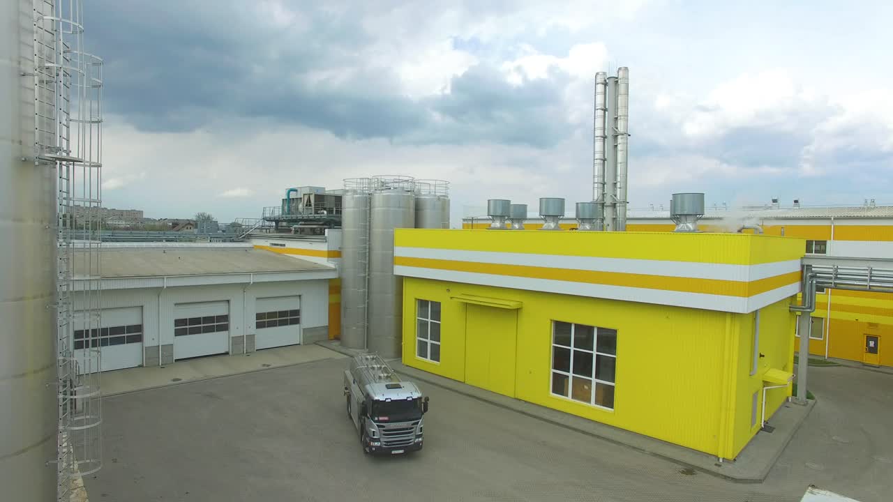 Industrial Area With Factory. Aerial view of a factory or industrial area surrounded by green fields